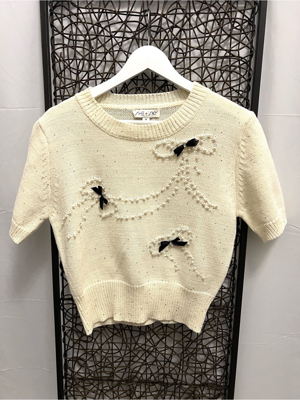 She + Sky cream-colored short Slv sweater black bow pearl embellishment crew M